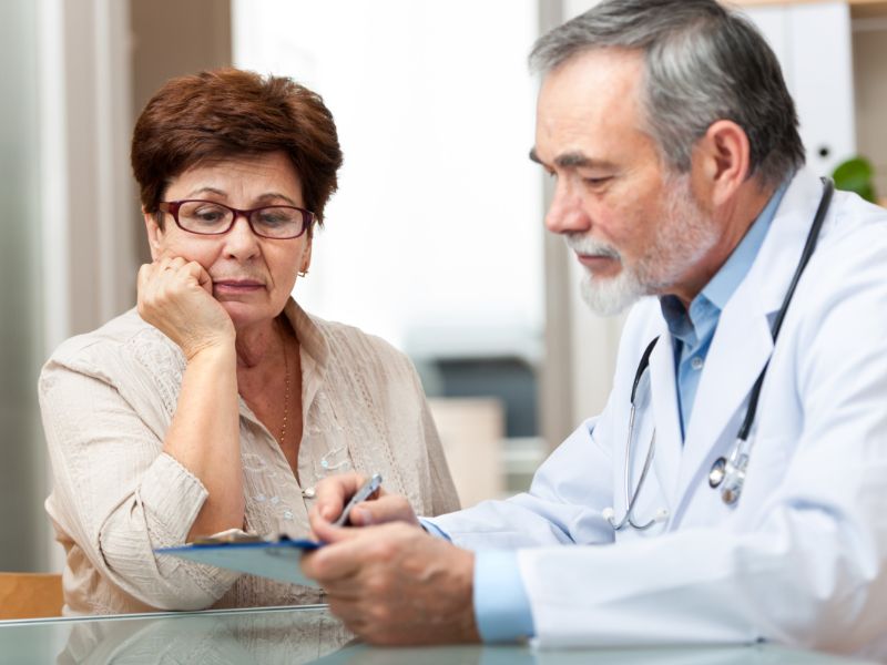 Doctor and patient looking at a document together