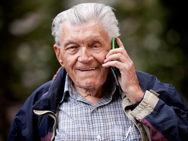Senior person on phone outdoors